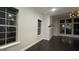 Living room with large windows, dark hardwood floors and modern lighting fixture at 1045 Kirkland Cir, Smyrna, GA 30080