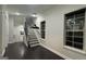 Spacious living room with dark hardwood floors, large windows, and staircase at 1045 Kirkland Cir, Smyrna, GA 30080
