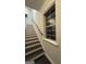 Stairway with dark treads and white risers leads to upper level with natural light from a window at 1045 Kirkland Cir, Smyrna, GA 30080