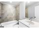 Bright bathroom featuring a combined bathtub and shower with grey tiling and a white vanity with ample counter space at 1045 Kirkland Cir, Smyrna, GA 30080