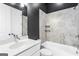 Well-lit bathroom with white vanity, toilet, and combined tub/shower featuring tiled walls and sleek fixtures at 1045 Kirkland Cir, Smyrna, GA 30080