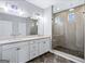 Dual sink bathroom featuring a glass shower enclosure and modern fixtures providing an elegant space at 1045 Kirkland Cir, Smyrna, GA 30080