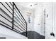 Stylish entryway boasting patterned wallpaper, dark wood floors, and a metal staircase railing at 1045 Kirkland Cir, Smyrna, GA 30080