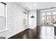 Bright living room with modern wallpaper, dark wood floors, and abundant natural light at 1045 Kirkland Cir, Smyrna, GA 30080