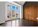 Inviting living room features large windows, dark floors, and unique wood accent wall at 1045 Kirkland Cir, Smyrna, GA 30080