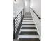Staircase featuring black handrails and dark wood treads with a white base rising to the upper level at 1045 Kirkland Cir, Smyrna, GA 30080