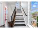 Staircase with black railings and geometric wallpaper at 1045 Kirkland Cir, Smyrna, GA 30080