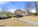 Back of house showing large yard, stone walkway, screened in deck, and patio at 2840 Riverfront Dr, Snellville, GA 30039