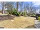Expansive backyard featuring mature trees, a shed, and a flat grassy area at 2840 Riverfront Dr, Snellville, GA 30039