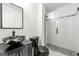 Bathroom features a unique marble bowl sink, black toilet and a glass door shower at 2840 Riverfront Dr, Snellville, GA 30039