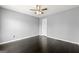 Bedroom featuring a modern ceiling fan, grey walls, dark hardwood floor and white door at 2840 Riverfront Dr, Snellville, GA 30039