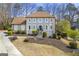 Charming two-story home with manicured lawn, mature trees, and a classic architectural design on a sunny day at 2840 Riverfront Dr, Snellville, GA 30039