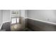Open floor plan with hardwood flooring and a large bright window with white trim at 2840 Riverfront Dr, Snellville, GA 30039