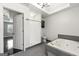 Bright main bathroom featuring a jetted tub, a shower, a toilet, and a vanity with lighting at 2840 Riverfront Dr, Snellville, GA 30039