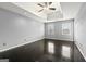 Spacious main bedroom featuring hardwood floors, tray ceiling, and natural light from two large windows at 2840 Riverfront Dr, Snellville, GA 30039