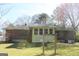 Exterior shot of a brick home with a spacious backyard featuring a garden at 6064 Monica Dr, Morrow, GA 30260