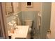 Bathroom featuring blue tile, white toilet and vanity at 6064 Monica Dr, Morrow, GA 30260