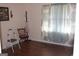 Bedroom with wood-look floors and window with patterned curtains at 6064 Monica Dr, Morrow, GA 30260