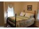 Bedroom with a four-poster bed, quilt, and patterned curtains at 6064 Monica Dr, Morrow, GA 30260