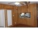 Dining area with wood paneled walls, access to the kitchen, and doors to the back at 6064 Monica Dr, Morrow, GA 30260