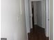 Hallway with dark wood-look floors and white doors at 6064 Monica Dr, Morrow, GA 30260
