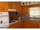 Functional kitchen with wooden cabinets, laminate countertops, and a vintage oven at 6064 Monica Dr, Morrow, GA 30260