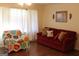 Inviting living room featuring a red sofa, throw pillows, and warm lighting at 6064 Monica Dr, Morrow, GA 30260