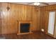 Living room with an electric fireplace, wood paneled walls, and vinyl flooring at 6064 Monica Dr, Morrow, GA 30260