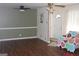 Cozy living room with wood floors, neutral walls, and a decorative ceiling fan at 6064 Monica Dr, Morrow, GA 30260