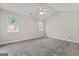 Spacious bedroom with neutral walls, plush carpet, vaulted ceiling and natural light from two windows at 217 Crystal Ct, Hampton, GA 30228