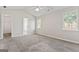 Bright bedroom featuring neutral walls, plush carpet, two windows, and access to the en-suite bathroom at 217 Crystal Ct, Hampton, GA 30228