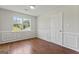 Cozy bedroom with wood-look flooring and wainscotting at 217 Crystal Ct, Hampton, GA 30228