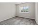 Carpeted bedroom features a large window offering natural light and neutral paint at 217 Crystal Ct, Hampton, GA 30228