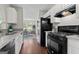 Efficient kitchen design with white cabinets and black appliances at 217 Crystal Ct, Hampton, GA 30228
