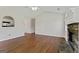 Open floorplan features hardwood floors, stone fireplace, pass through to kitchen and large windows at 217 Crystal Ct, Hampton, GA 30228