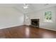 Open living room with vaulted ceiling, hardwood floors, stone fireplace and lots of natural light at 217 Crystal Ct, Hampton, GA 30228