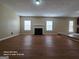 Spacious living room with hardwood flooring, fireplace, and natural light from windows at 115 Portland Pl, Jonesboro, GA 30238