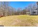 Expansive backyard with lush greenery, leading up to a deck and pergola, perfect for outdoor enjoyment at 821 Hood Rd, Fayetteville, GA 30214