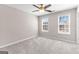 Bedroom featuring modern ceiling fan and windows with natural light at 821 Hood Rd, Fayetteville, GA 30214