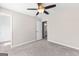 Bedroom with ceiling fan, view to bath, and access to closet space at 821 Hood Rd, Fayetteville, GA 30214