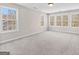 Bright bedroom with multiple windows and neutral carpeting provides ample natural light at 821 Hood Rd, Fayetteville, GA 30214