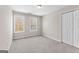 Bedroom featuring neutral carpeting, closet space, and natural light from updated windows at 821 Hood Rd, Fayetteville, GA 30214