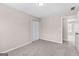 Carpeted bedroom includes closet and doorway, with plenty of natural light at 821 Hood Rd, Fayetteville, GA 30214
