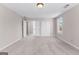 Spacious bedroom featuring neutral carpeting, closet, and entry to another room at 821 Hood Rd, Fayetteville, GA 30214