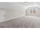 Neutral carpeted bonus room with dormer window, closet, and neutral colored walls at 821 Hood Rd, Fayetteville, GA 30214