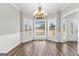 Bright dining room featuring large windows, modern chandelier, and beautiful hardwood floors at 821 Hood Rd, Fayetteville, GA 30214