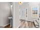 Inviting entryway with tiled sink area, a decorative front door, and staircase at 821 Hood Rd, Fayetteville, GA 30214