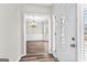 Elegant foyer with chandelier, wood-look floors, and natural light from the sidelight window at 821 Hood Rd, Fayetteville, GA 30214
