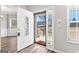 Inviting entryway with decorative glass door, wood-look floors, and sidelight windows at 821 Hood Rd, Fayetteville, GA 30214