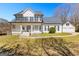 Charming two-story home with a welcoming front porch and a well-manicured lawn at 821 Hood Rd, Fayetteville, GA 30214